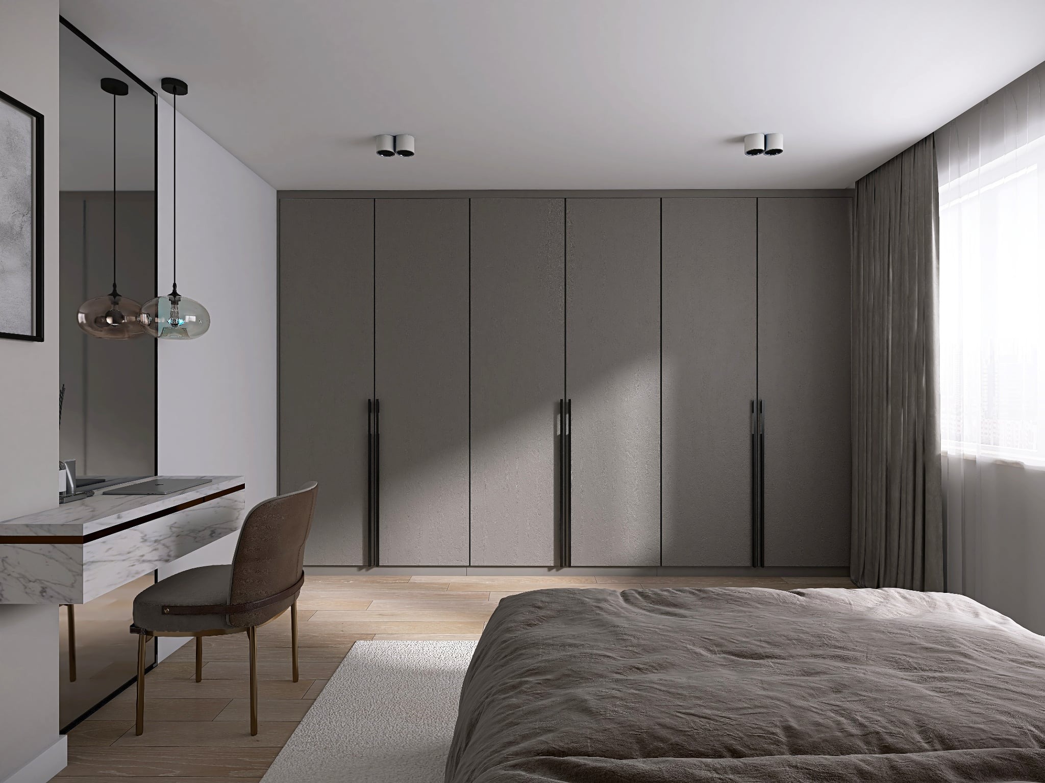 Sypialnia w stonowanej kolorystyce: szara zabudowa szafy wnękowej z długimi uchwytami, toaletka z marmurowym blatem i wiszące lampy nad nią, łóżko z szarą pościelą.