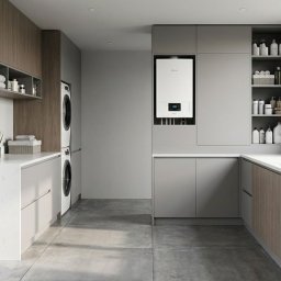 TERMO-MAJSTER Serwis pieców CO - Nowoczesna kotłownia z piecem gazowym w zabudowie, pralką i suszarką w kolumnie, jasnymi szafkami i dużym oknem z widokiem na zieleń. Minimalistyczny design.