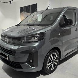 Lobo - Szary, nowoczesny bus Citroen z aluminiowymi felgami, prezentowany w jasnym, minimalistycznym salonie z oświetleniem punktowym i stonowanym tłem.