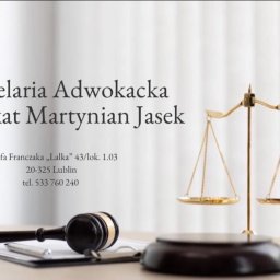Kancelaria Adwokacka Adwokat Martynian Jasek - Kancelaria Adwokacka: waga sprawiedliwości, drewniany młotek sędziowski i notatnik na jasnym tle. Adwokat Martynian Jasek, Lublin, ul. Józefa Franczaka.