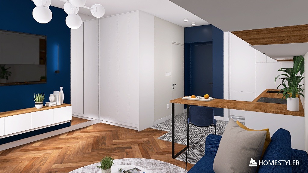 Nowoczesne wnętrze mieszkania z niebieską ścianą, drewnianą podłogą w jodełkę i białymi meblami. Widoczny fragment kuchni z drewnianym blatem i rośliną doniczkową.