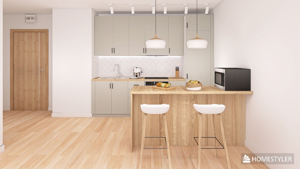 Jasna kuchnia z drewnianym blatem i białymi hokerami. Nad blatem wiszą dwie lampy. Na blacie owoce i mikrofalówka. W tle białe płytki na ścianie.