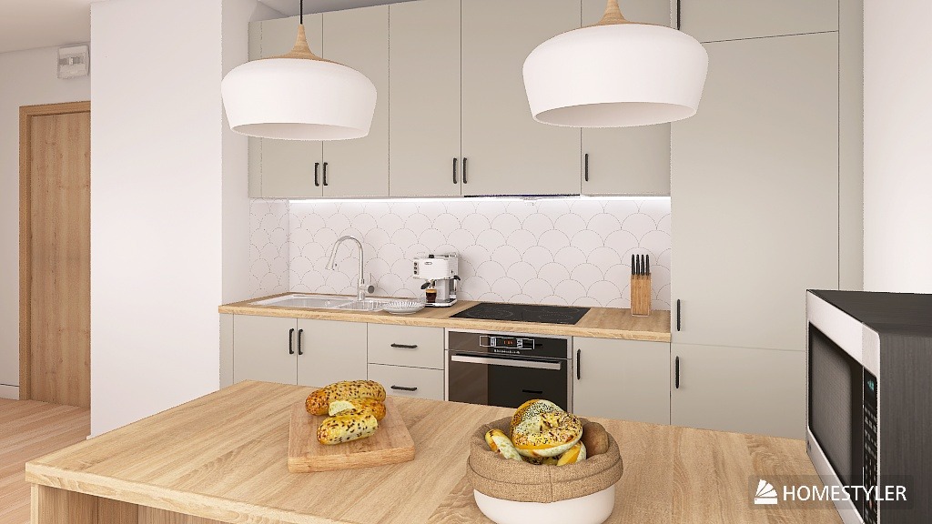 Jasna kuchnia z drewnianym blatem i wyspą. Nad blatem wiszą dwie białe lampy. Na blacie leżą bagietki na desce i w koszyku. Białe płytki na ścianie w kształcie rybiej łuski.