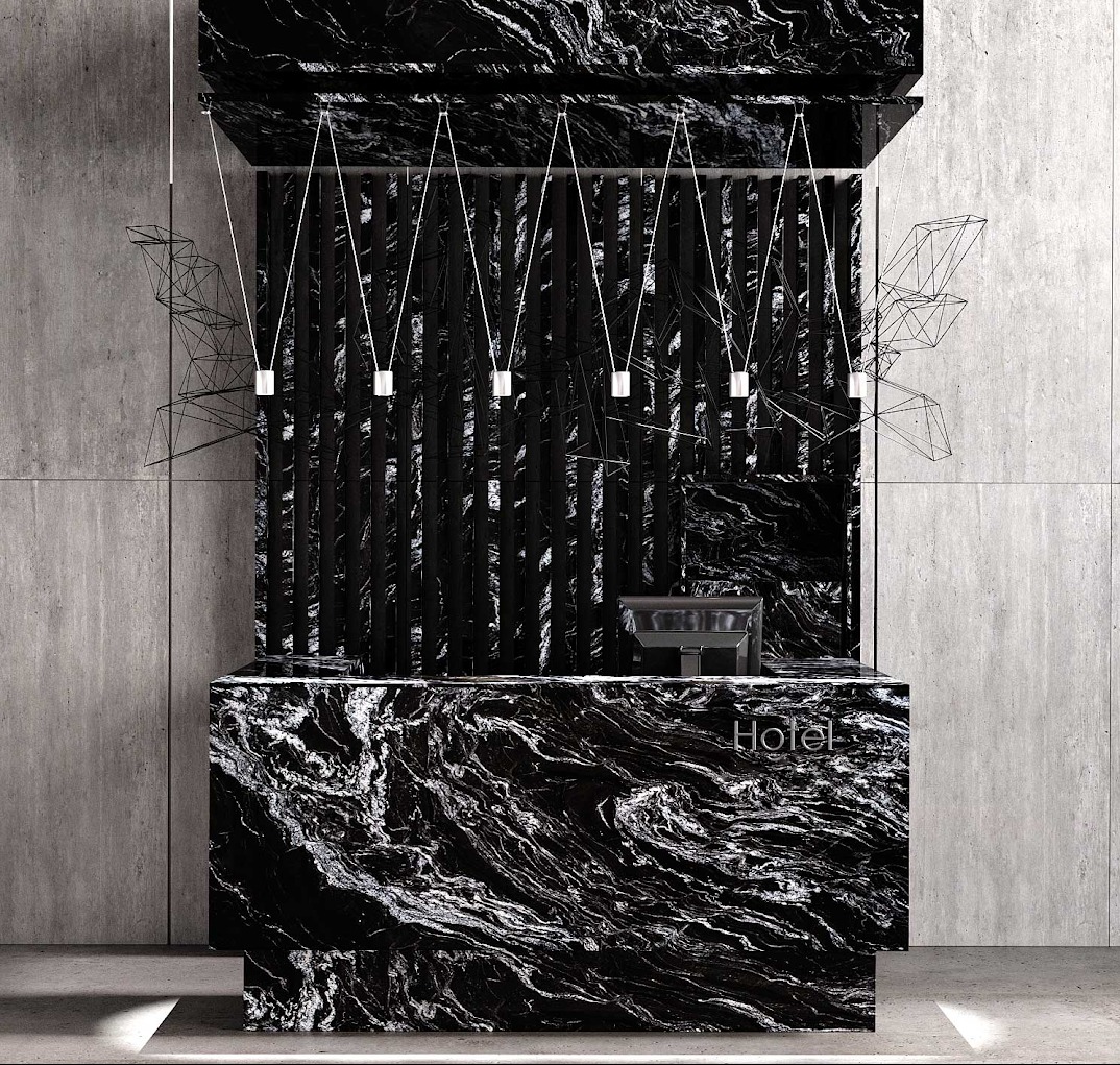 Recepcja hotelowa z blatem z czarnego kamienia o unikalnym wzorze żyłkowania, podświetlona minimalistycznymi lampami. Tło stanowi betonowa ściana.