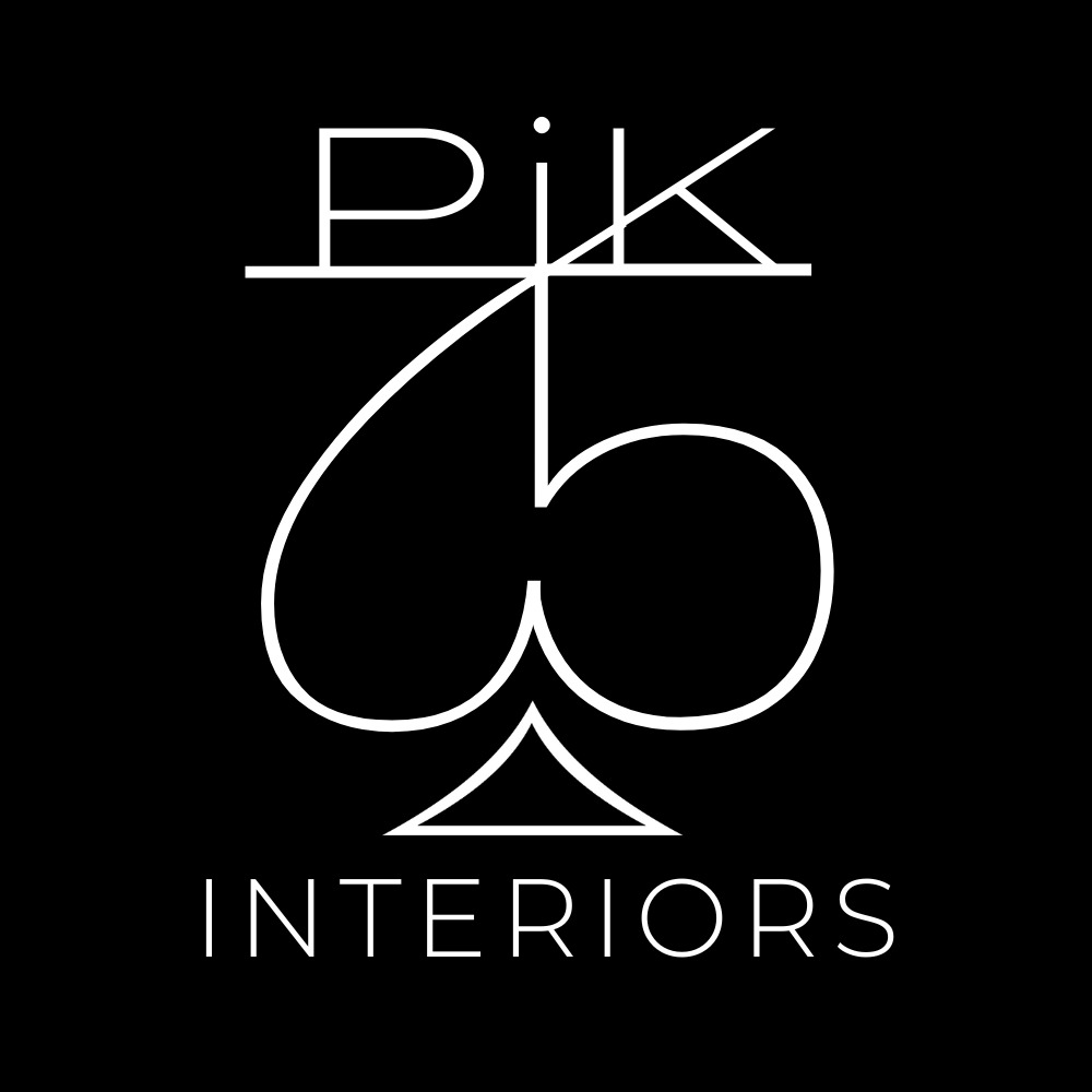 Minimalistyczne logo 'PIK Interiors' z symbolem pika w Bełchatowie. Biały, geometryczny design na czarnym tle, podkreślający nowoczesny charakter firmy.