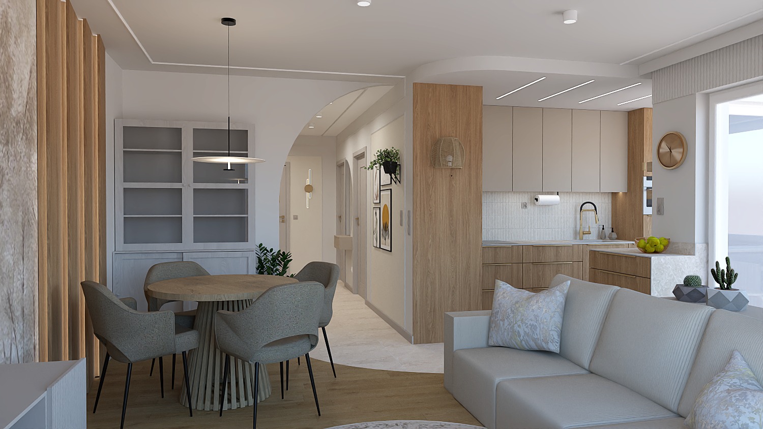 Jasne, przestronne wnętrze z okrągłym stołem i krzesłami, otwartą kuchnią w beżach i szarościach oraz sofą z poduszkami. Minimalistyczny design z drewnianymi akcentami.