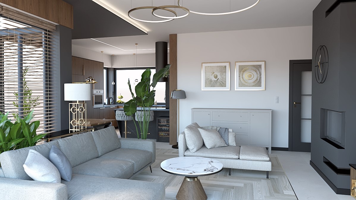 Elegancki salon z szarą sofą narożną, marmurowym stolikiem i otwartą kuchnią w tle. Nowoczesne oświetlenie i dekoracje podkreślają minimalistyczny styl wnętrza.