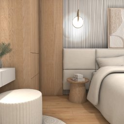 Nowoczesna sypialnia w beżach: łóżko z zagłówkiem, toaletka z lustrem, pufa, drewniane panele i abstrakcyjny obraz. Minimalistyczny design, ciepłe oświetlenie.