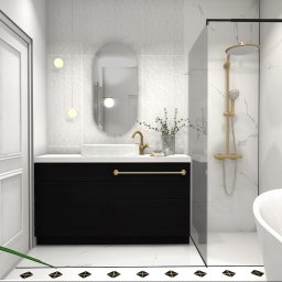 Koddo design - Elegancka łazienka w Kolbudach: białe marmurowe płytki, czarna szafka pod umywalką, złota armatura i kabina prysznicowa ze złotym deszczownicą.