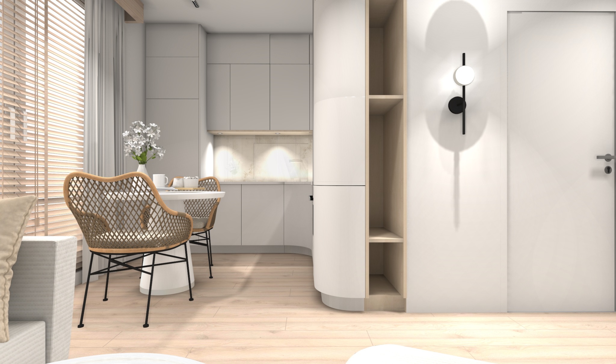 Jasne wnętrze: minimalistyczna kuchnia z jadalnią, rattanowe krzesła przy okrągłym stole, zabudowa meblowa z półkami i designerski kinkiet na białej ścianie.