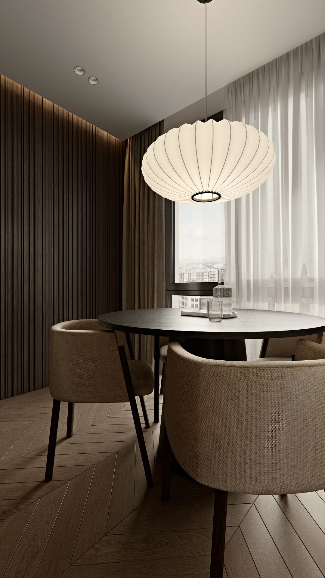 Jadalnia w neutralnych barwach: okrągły stół z krzesłami, designerska lampa, drewniana ściana i parkiet w jodełkę. Minimalistyczny wystrój z widokiem na miasto.