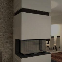 Nowoczesny kominek narożny z przeszklonym paleniskiem, wkomponowany w jasne wnętrze z elementami dekoracyjnymi. Widoczne detale wykończenia i aranżacja przestrzeni.