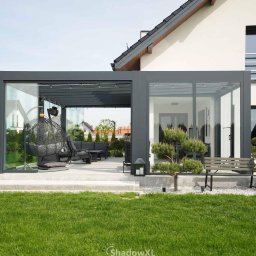 Weranda QubeXL idealnie łączy się z bryłą domu – stabilna, narożna zabudowa z modułów tworzy spójną i elegancką całość.