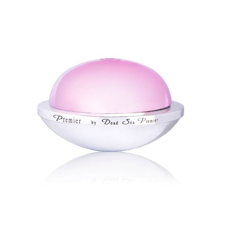 Krem do twarzy Premier by Dead Sea Premier w okrągłym, białym opakowaniu z różową kopułą, na białym tle z odbiciem. Minimalistyczna fotografia produktowa.
