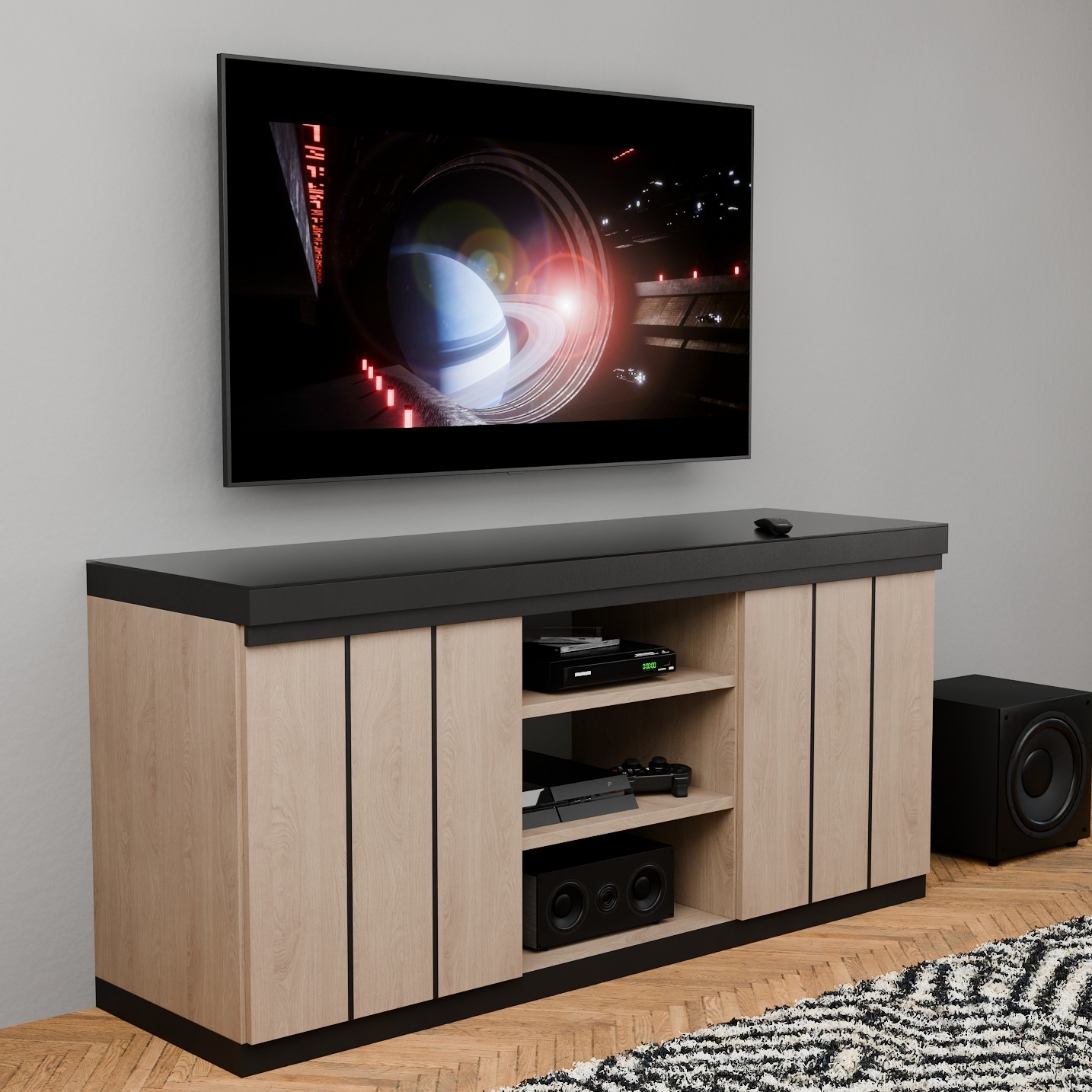 Nowoczesna szafka RTV z jasnego drewna i czarnym blatem, na tle ściany z telewizorem. Widoczny subwoofer i dywan w geometryczne wzory.