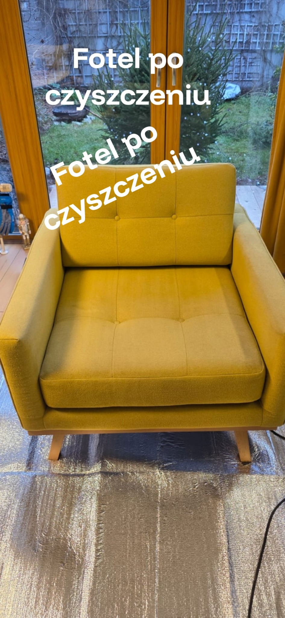 Żółty fotel po czyszczeniu, ustawiony na folii ochronnej, widok z przodu na tle okna z widokiem na ogród. Widoczne drewniane nóżki i pikowane siedzisko.