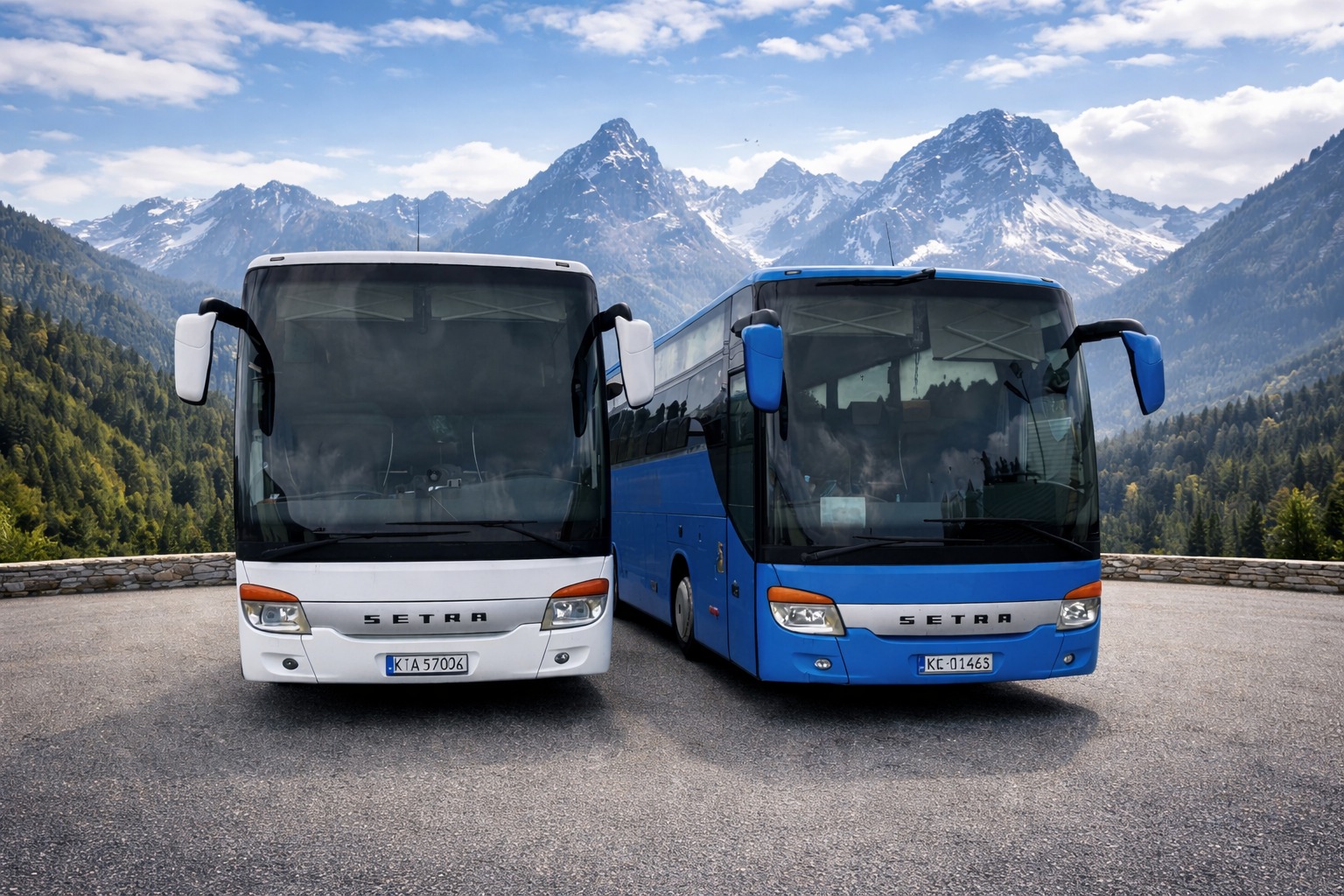 Dwa autokary Setra: biały i niebieski, stojące na tle górskiego krajobrazu z ośnieżonymi szczytami. Ujęcie z przodu, ukazujące detale pojazdów i malownicze otoczenie.