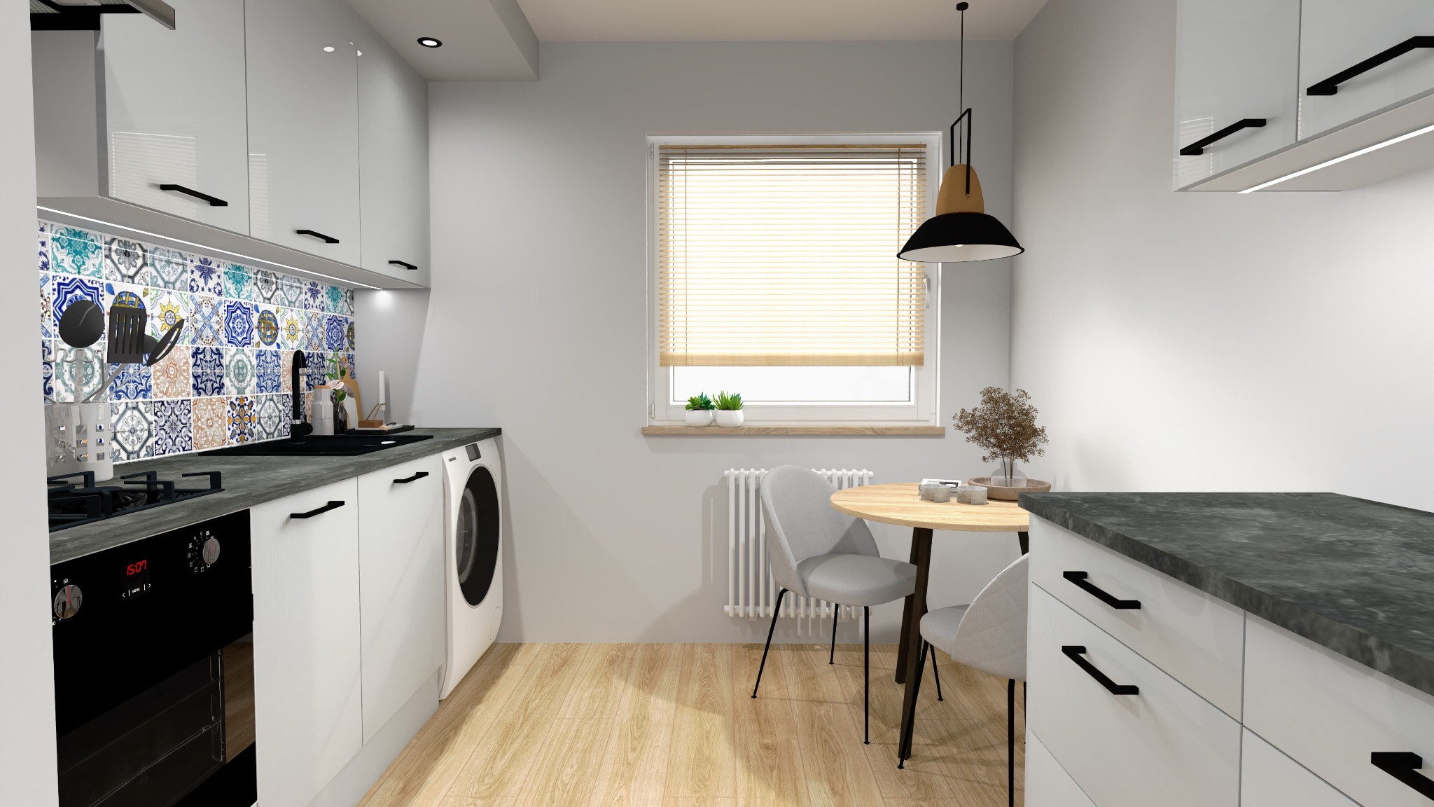 Jasna kuchnia z białymi szafkami, blatem w kolorze grafitu i dekoracyjnymi płytkami nad blatem. Okrągły stół z szarymi krzesłami i lampa wisząca.