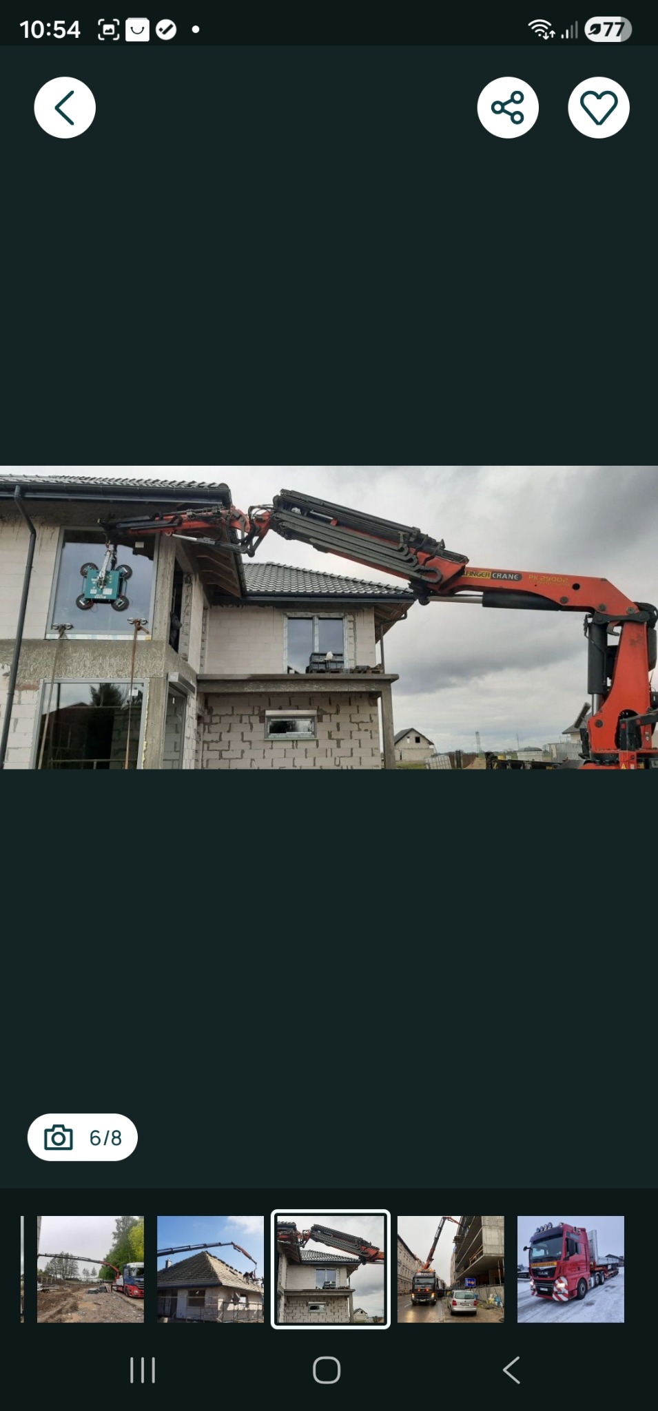 Ciężarówka z dźwigiem Palfinger PK 29004 montuje okno w surowym budynku. Widoczne przyssawki do szkła. Transport ciężarowy.