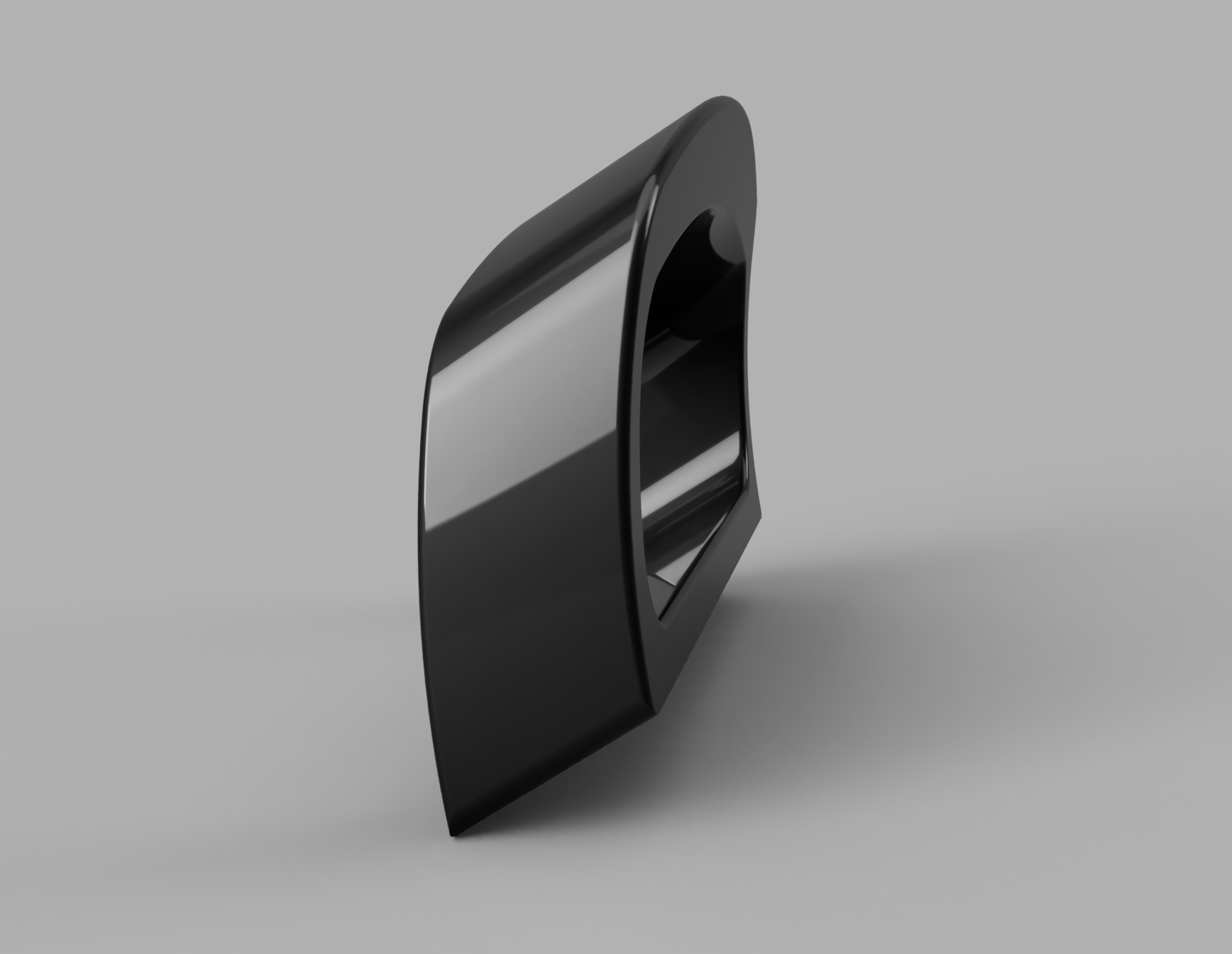 Czarny, błyszczący element z tworzywa, prawdopodobnie uchwyt lub obudowa, widoczny z boku na szarym tle. Model 3D lub prototyp wykonany w technologii CNC.