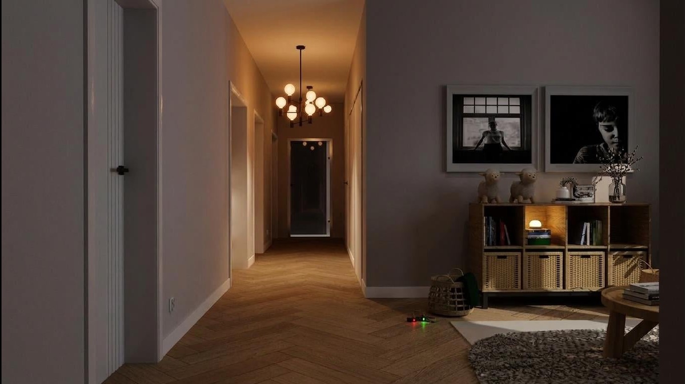 Nowoczesny korytarz z parkietem w jodełkę, oświetlony kulistym żyrandolem. Na ścianie półka z dekoracjami i czarno-białymi zdjęciami. Widok na drzwi na końcu korytarza.