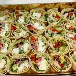 KRAKPRESS SPÓŁKA Z OGRANICZONĄ ODPOWIEDZIALNOŚCIĄ - Tortille z kurczakiem, serem i warzywami w pudełku cateringowym. Różne nadzienia, świeże składniki, estetyczna prezentacja. Idealne na firmowe lunche.