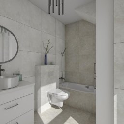 Kamil Skibicki - Nowoczesna łazienka z owalnym lustrem, białą umywalką na szafce, podwieszaną toaletą i wanną. Szare płytki na ścianach i podłodze. Minimalistyczne oświetlenie sufitowe.