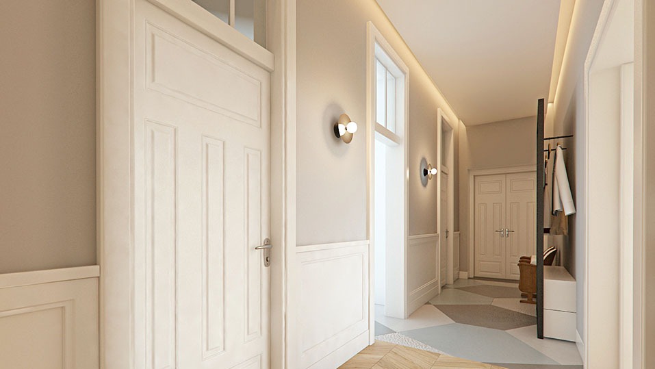 Białe, klasyczne drzwi z ozdobnymi panelami ściennymi w jasnym korytarzu. Geometryczna podłoga i nowoczesne oświetlenie dodają elegancji.