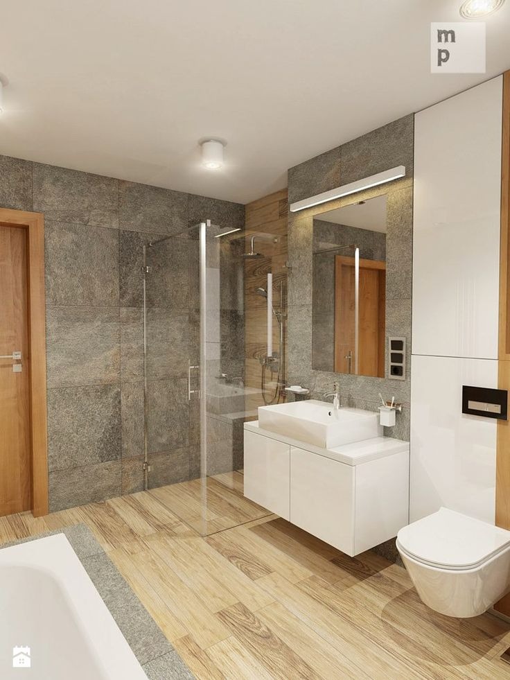 Nowoczesna łazienka z szarą, kamienną ścianą, drewnianą podłogą i kabiną prysznicową ze szkła. Biała umywalka z szafką i toaleta w minimalistycznym stylu.