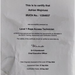 Certyfikat IRATA Adriana Wojniusza, potwierdzający kwalifikacje Level 1 Rope Access Technician, z datami ważności i numerem identyfikacyjnym.