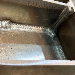 StegWeld - Szczegółowe zbliżenie na precyzyjne spawy łączące metalowe elementy konstrukcji, ukazujące estetyczne i trwałe połączenie. Widoczne ślady obróbki.