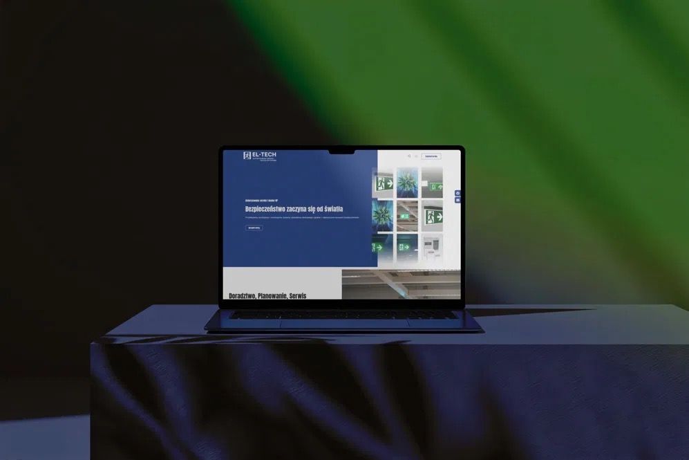 Laptop prezentuje stronę internetową firmy EL-TECH z motywem bezpieczeństwa i oświetlenia awaryjnego, na tle zielono-czarnym z efektem cienia.