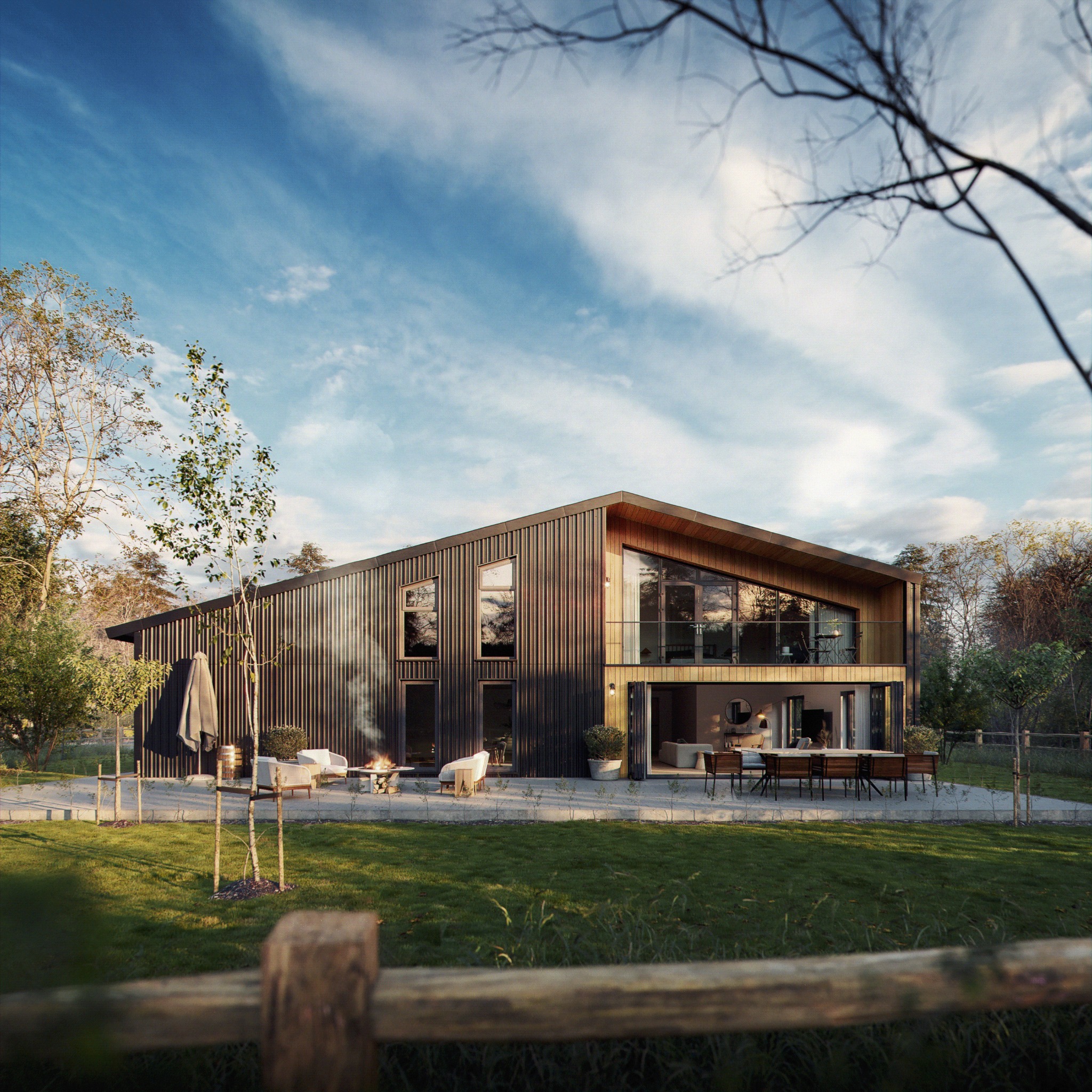 Wizualizacja nowoczesnego domu z ciemną, pionową elewacją, dużymi przeszkleniami i tarasem z paleniskiem. Ujęcie zza drewnianego płotu, w tle błękitne niebo.