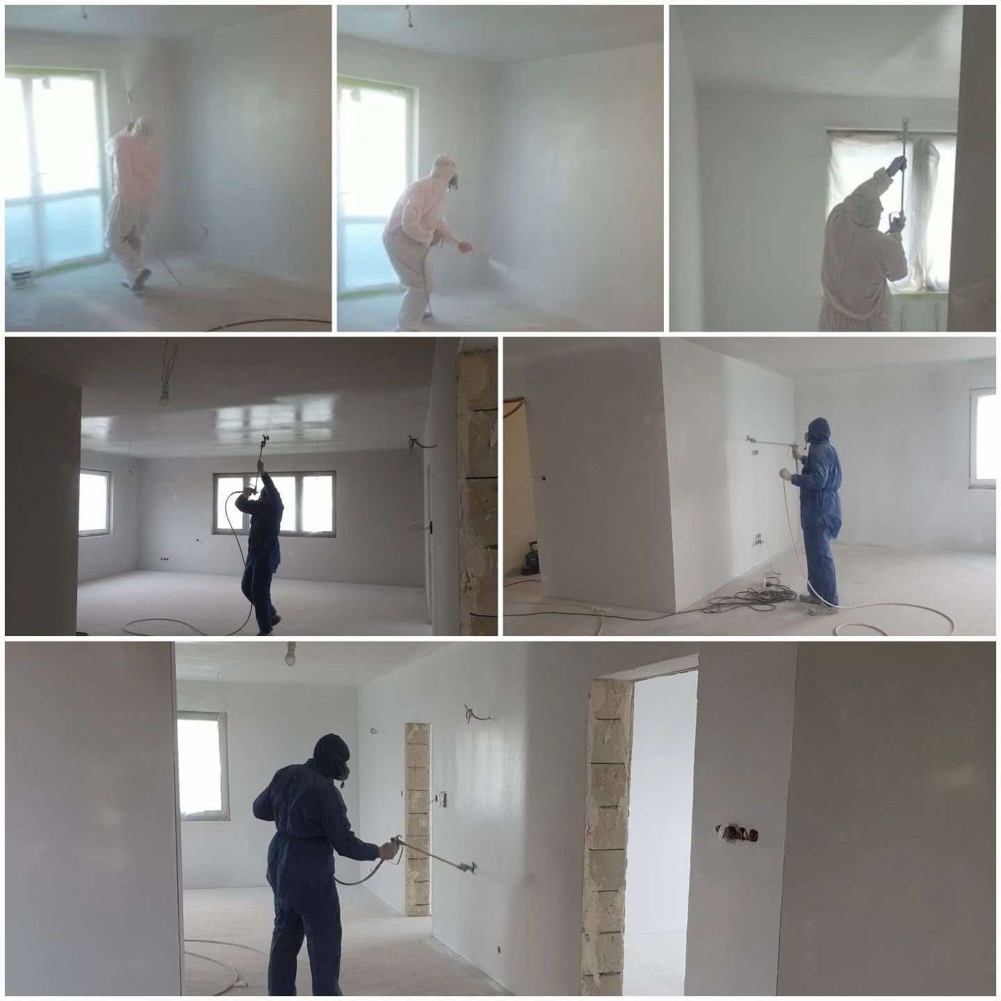 Praca malarska natryskowa w jasnym wnętrzu. Pracownik w kombinezonie ochronnym aplikuje farbę na ściany za pomocą pistoletu natryskowego. Widoczne okna i przygotowane pomieszczenie.