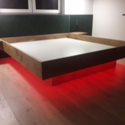 TOMASZEWSKI MEBLE PAWEŁ TOMASZEWSKI - Nowoczesna antresola z podświetleniem LED w Prabutach. Drewniana konstrukcja z białym blatem, czerwone światło odbija się od podłogi. Nietypowe rozwiązanie aranżacyjne.