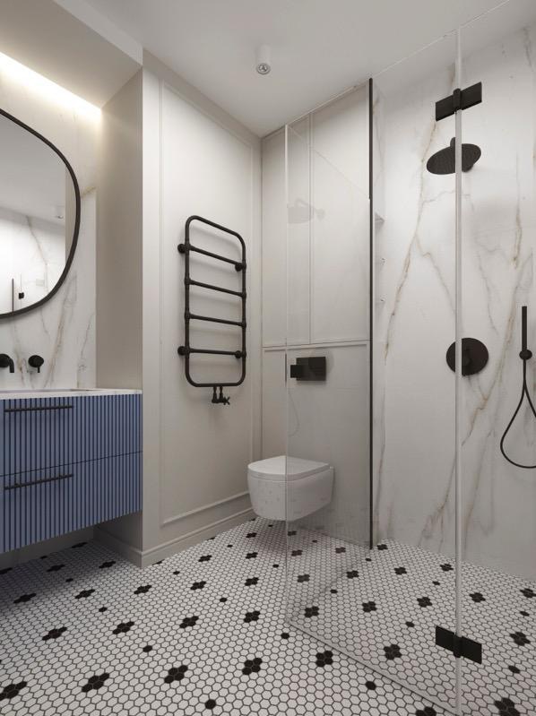 Elegancka łazienka z kabiną prysznicową typu walk-in, biało-czarną mozaiką na podłodze i niebieską szafką pod umywalką. Minimalistyczny design z czarnymi akcentami.