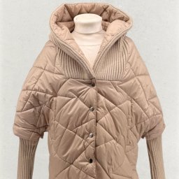 KM INVESTMENT POLAND PATRYK MIŁOSZ - Beżowa, pikowana kurtka z kapturem i dzianinowymi rękawami, zapinana na guziki, na manekinie. Widoczne detale: faktura pikowania, splot dzianiny.