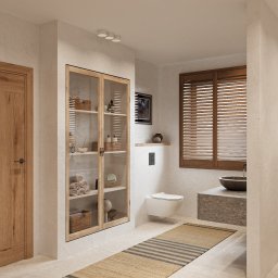 PRACOWNIA PROJEKTOWA WERONIKA STEFFEN-LOTARSKA - Jasna łazienka w stylu rustykalnym z drewnianą szafką, beżowym dywanikiem i umywalką z kamienia. Okno z drewnianymi żaluzjami i minimalistyczna toaleta podnoszą walory estetyczne.