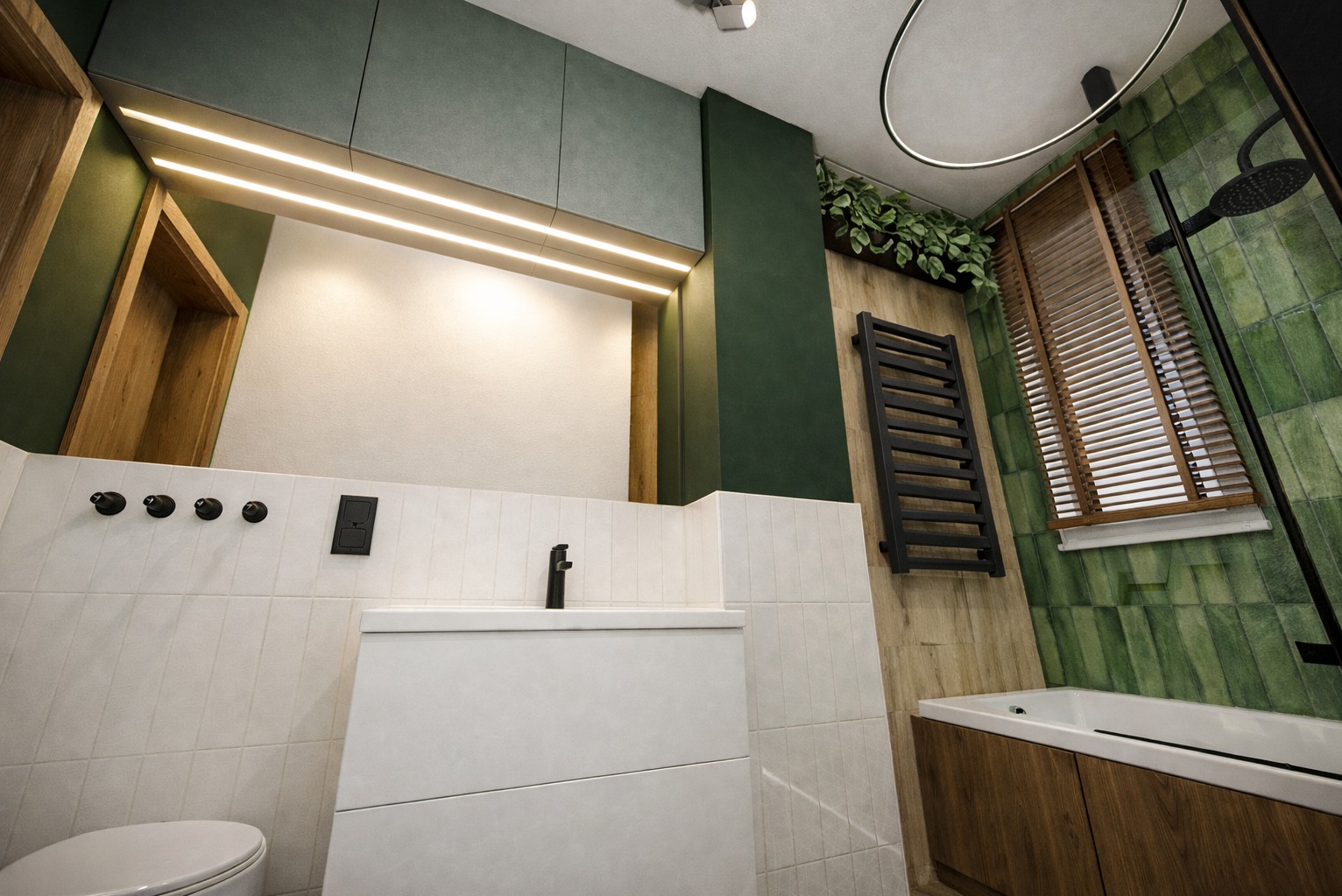Nowoczesna łazienka z zielonymi akcentami: płytki w odcieniach zieleni, drewniane elementy, biała umywalka i czarne detale, takie jak grzejnik i armatura.