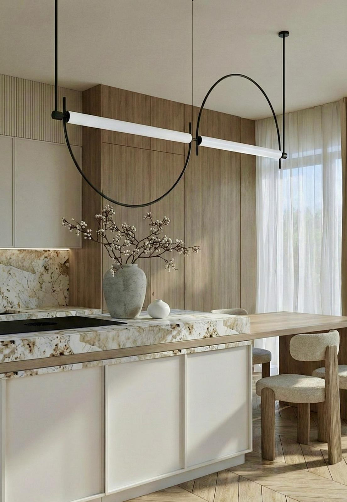 Nowoczesna kuchnia z marmurowym blatem, minimalistycznym oświetleniem i drewnianymi akcentami. Wazon z gałązkami na blacie dodaje subtelności.