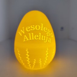 Grzegorz Pawul - Żółte, podświetlone jajo z napisem 'Wesołego Alleluja' i wzorem gałązek, wykonane w technologii addytywnej. Unikalny, świąteczny element dekoracyjny.