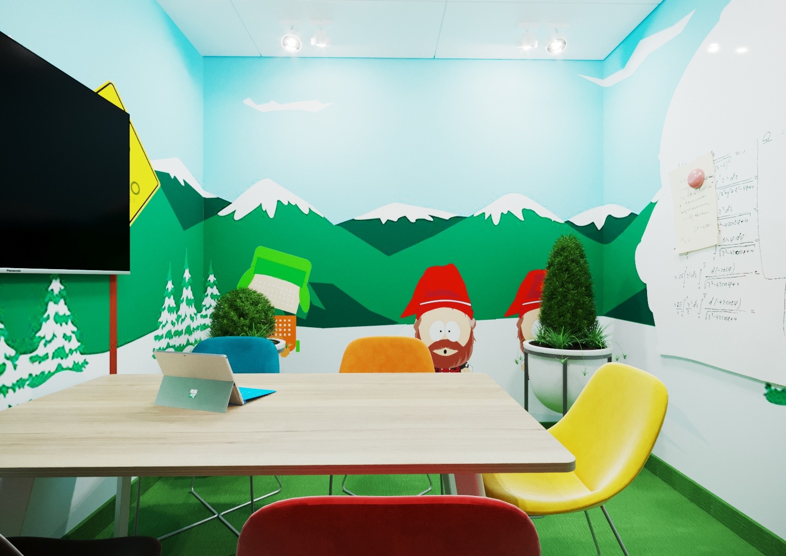 Kolorowe biuro z motywem South Park: ściany z górami, postacie z kreskówki, nowoczesne meble (żółte krzesło, drewniany stół) i tablica suchościeralna z notatkami.