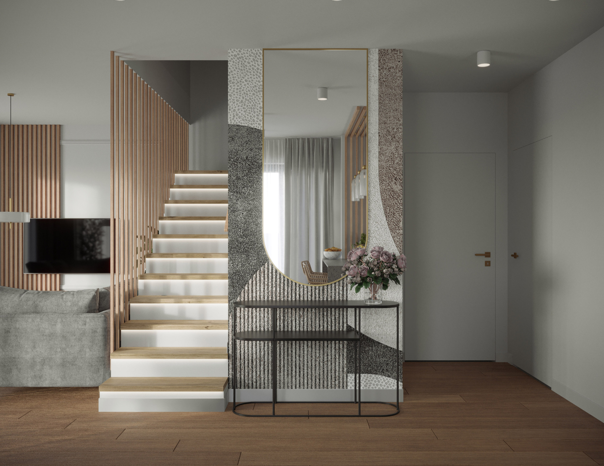Nowoczesne wnętrze z podświetlanymi schodami, lustrem w dekoracyjnej ramie i minimalistyczną konsolą z kwiatami. Widoczny fragment sofy i drewniane lamele na ścianie.