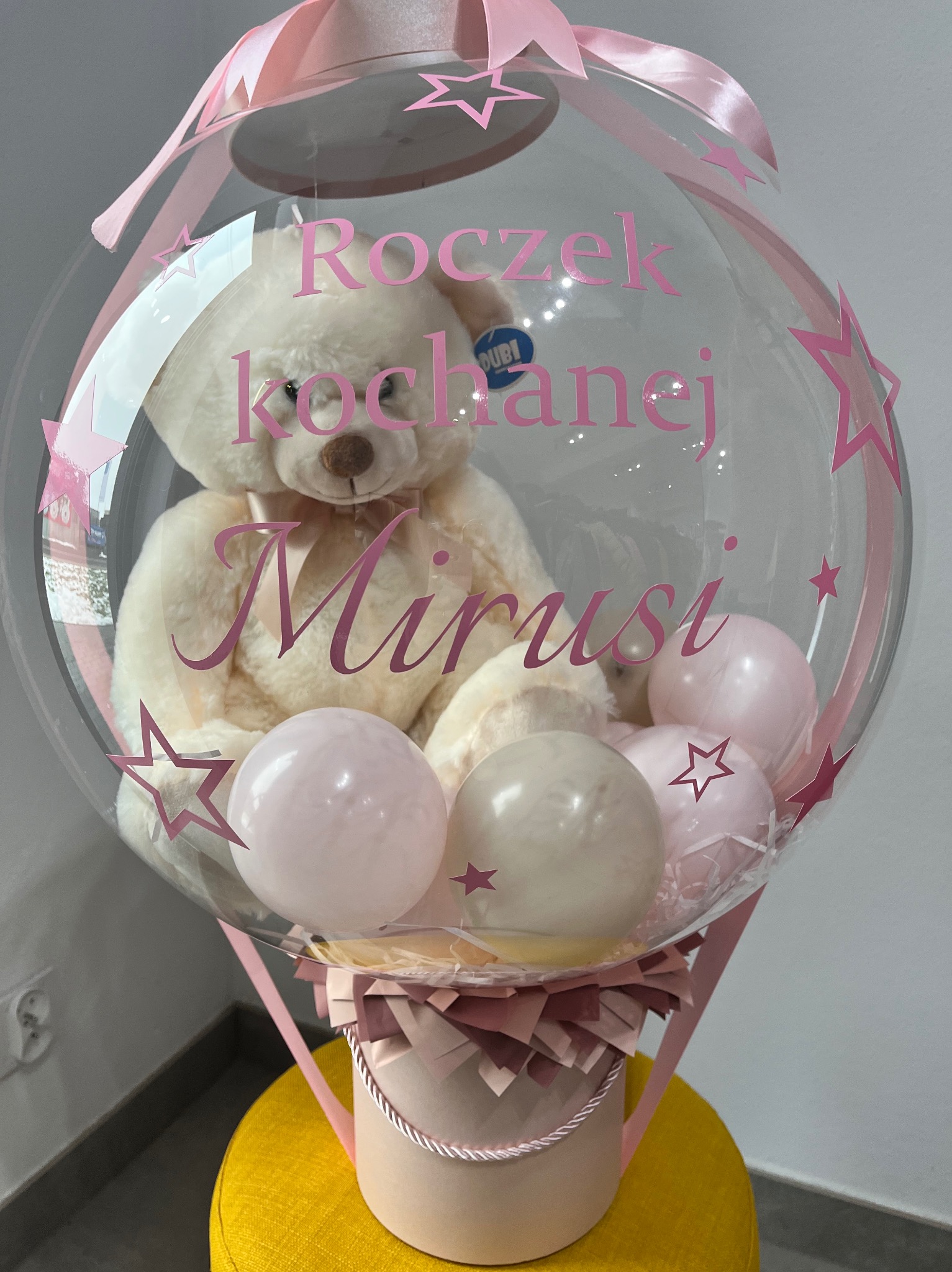 Personalizowany balon z misiem i napisem 'Roczek kochanej Mirusi' w różowej kolorystyce, umieszczony w ozdobnym pudełku. Idealny prezent na roczek.