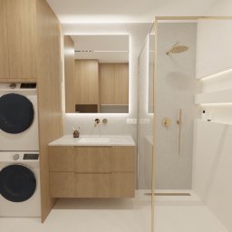 SPACE CONCEPT- PROJEKTOWANIE WNĘTRZ JOANNA MACIEJEWSKA - Nowoczesna łazienka z drewnianymi akcentami: szafka pod umywalką, pralka z suszarką w zabudowie, kabina prysznicowa ze złotymi detalami i podświetlane półki.