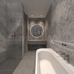 Remonty wykonczenia Krzysztof Barciszewski - Nowoczesna łazienka z kabiną prysznicową, okrągłym lustrem z podświetleniem i białą wanną. Szare ściany z efektem kamienia, minimalistyczny design.