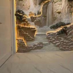 Bud-Max.Air Yurii Tepliuk - Relief ścienny z motywem wodospadu, podświetlony ciepłym światłem LED, tworzący trójwymiarowy efekt. Dekoracja w jasnych, naturalnych barwach.