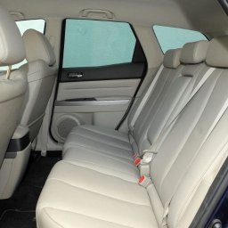 Piotr Kozłowiecki - Wnętrze samochodu z jasną skórzaną tapicerką, widok na tylne siedzenia. Czyste i zadbane wnętrze pojazdu z Jeleniej Góry, gotowe do komfortowej podróży.