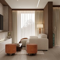 Martyna Koperska Wnętrza - Nowoczesny salon z biokominkiem, beżową sofą i pomarańczowymi pufami. Drewniane panele ścienne i duże okno z zasłonami tworzą przytulną atmosferę.