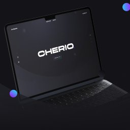 Cherio - Mateusz Czerewko - Laptop z wyświetloną stroną internetową o minimalistycznym designie, z logo 'CHERIO' na ciemnym tle. Widoczne menu nawigacyjne i gradientowe kule w tle.